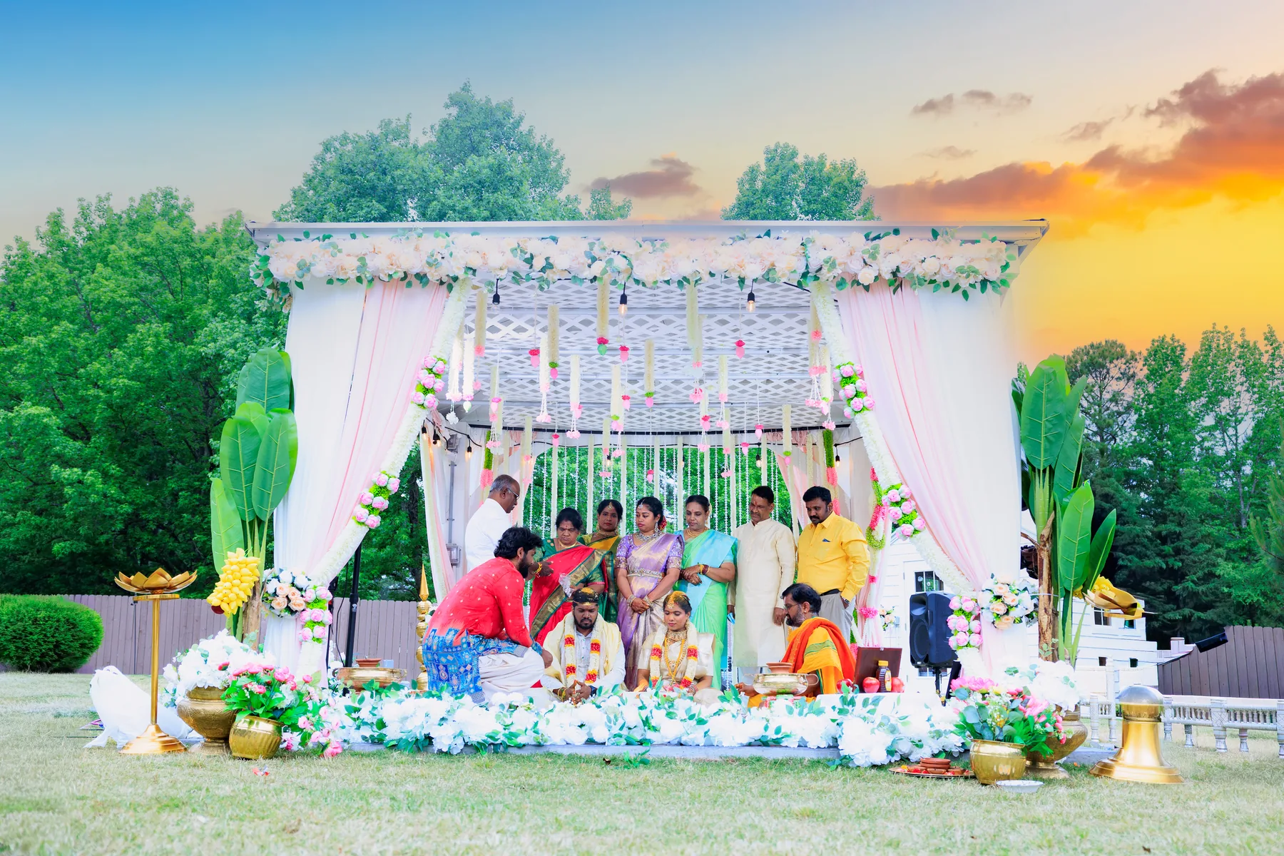 Outdoor South Indian wedding mandap decorated with flowers at sunset in the Raleigh Triangle, North Carolina