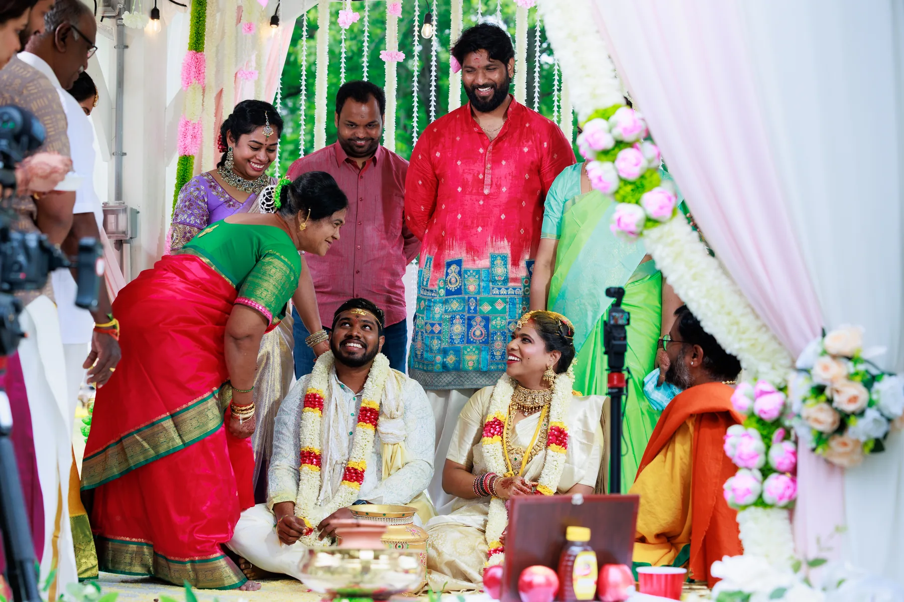 South Indian wedding ceremony with flower garlands as family blesses the seated couple, Raleigh NC